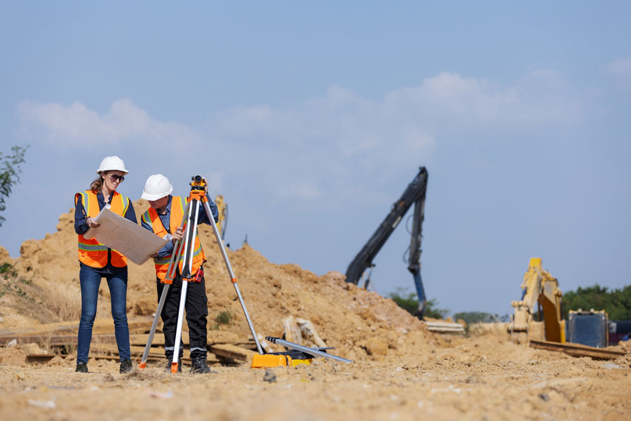 two construction surveyors