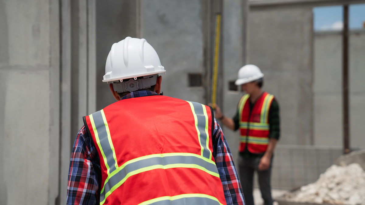 two workers in red